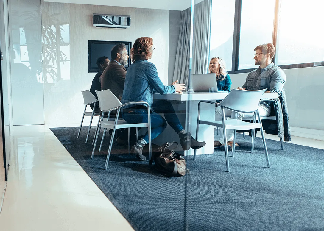 Advisors and clients meeting around a table